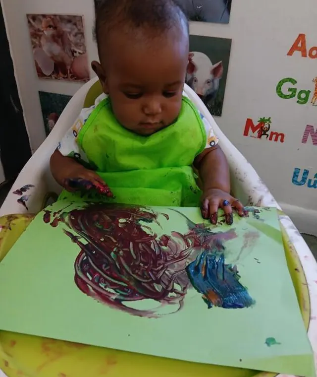 Young learner painting at Leading Learners Academy